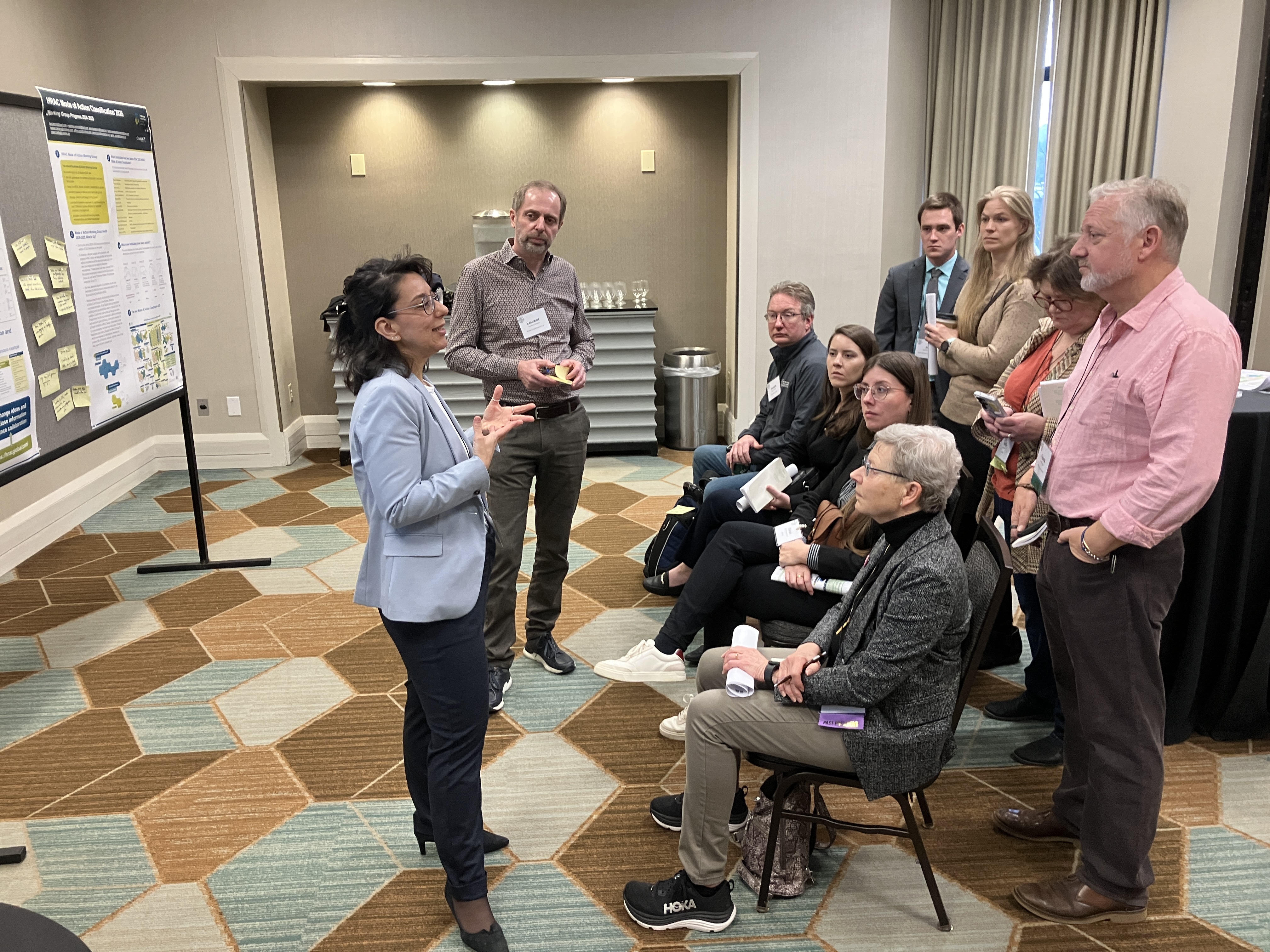 Conference coordinators addressing a small crowd